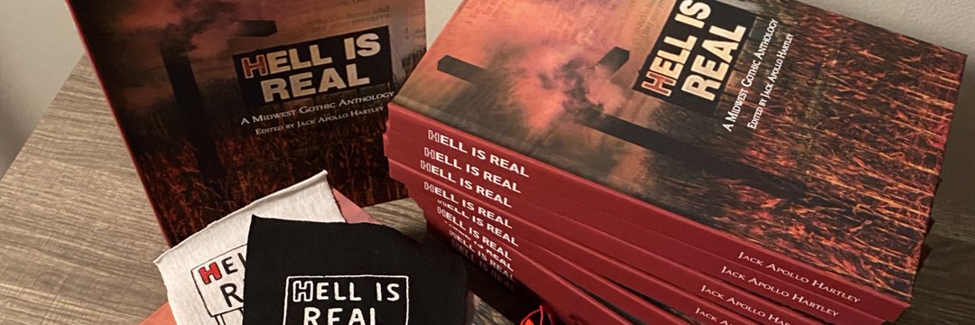 Copies of HELL IS REAL, a red and black book with a cross and a billboard on the cover.